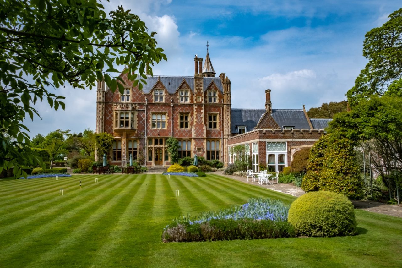 Striped lawn leading to stately home